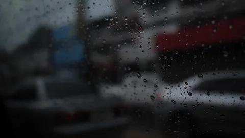 Slow motion, rain drops on window with car stopped on road traffic jam Stock Footage 113895296