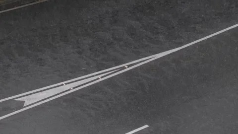 Slow Motion Rain Falling on Asphalt Road with Traffic Markings Stock Footage 326362293