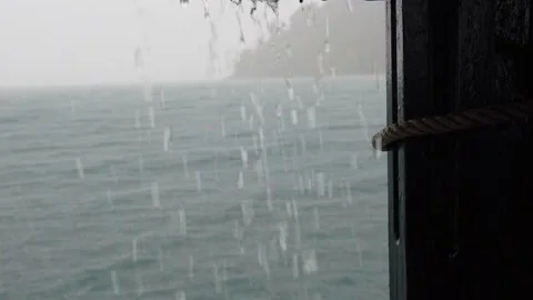 Slow Motion of Rain Falling on a Boat , Tilt Down to Red Rail 1 13 'Minute Stock Footage 148273944