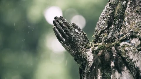 Slow motion rain falling on the hands of an angel statue at Bernardine Cemetery Stock Footage 336734065
