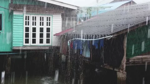 Slow Motion Rain on Washing and Huts Thailand Stock Footage 148358082