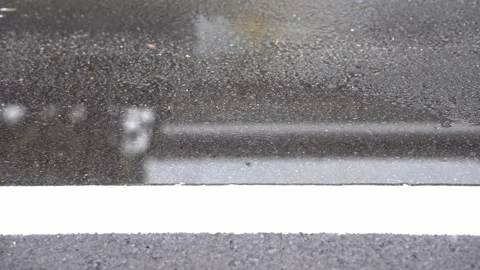 Slow Motion, rain water drops falling into road on asphalt, Stock Footage 143469364