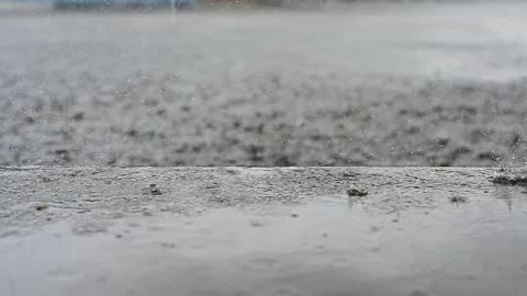 Slow Motion, rain water drops falling into big puddle on asphalt, Stock Footage 150639445