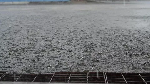 Slow Motion, rain water drops falling into big puddle on asphalt, Stock Footage 150642693