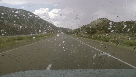 Slow motion rain on windshield, driving through Utah desert I70. Stock Footage 95163453