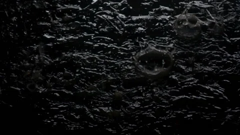 Slow motion raindrops fall into a large puddle as a background. Stock Footage 114295435