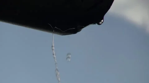 Slow motion raindrops fall from the roof Stock Footage 40685855