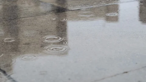 Slow motion raindrops falling on concrete paving slabs outdoors 스톡 동영상 116387082