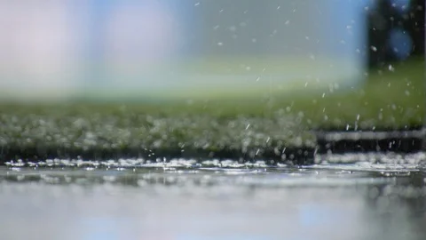 Slow motion raindrops splashing on the ground of football field Stock Footage 102105611
