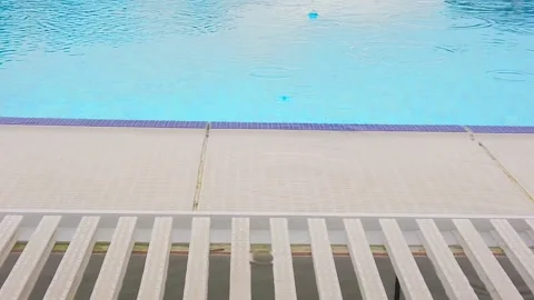 Slow motion. Raindrops on surface of water in pool. Close-up. Stock Footage 133707978