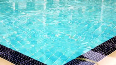 Slow motion. Raindrops on surface of water in pool. Close-up. Stock Footage 133707993