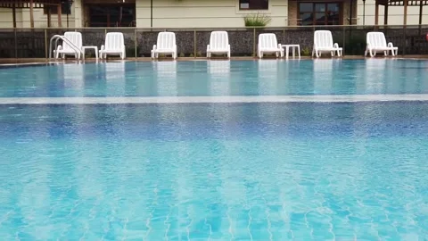 Slow motion. Raindrops on surface of water in pool. Close-up. Vidéo 133708013
