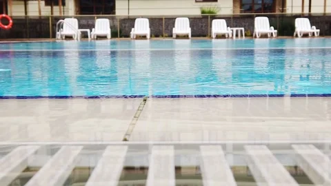 Slow motion. Raindrops on surface of water in pool. Close-up. Stock Footage 133708015