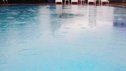 Slow motion. Raindrops on surface of water in pool. Close-up. Stock Footage 133708022