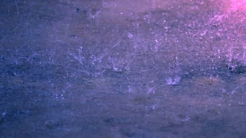 Slow motion raining droplets falling on ground Stock Footage 82630841