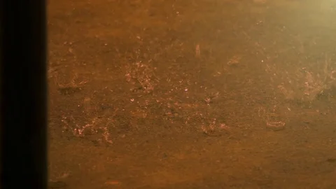 Slow motion raining droplets falling on ground Stockbeeldmateriaal 82631801