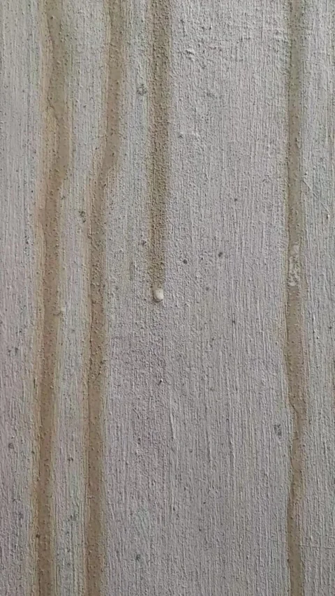 Slow motion of rainwater dripping down a weathered concrete wall Stock Footage 333634288