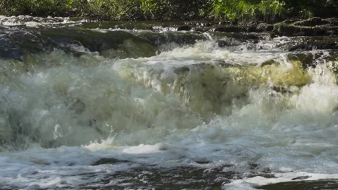 Slow motion of rapid river water over rocks Stock Footage 166598009