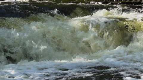 Slow motion of rapid river water over rocks Stock Footage 166598060