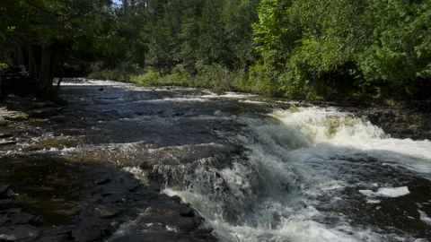 Slow motion of rapid river water over rocks Stock Footage 166599214