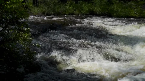 Slow motion of rapid river water over rocks Stock Footage 166630920