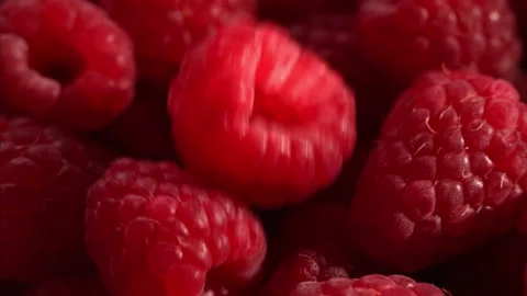Slow motion raspberry falling onto fresh pile. 動画素材 328985459