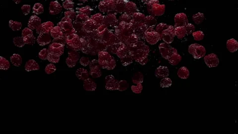 Slow motion raspberry falling into transparent water on black background 動画素材 168727182