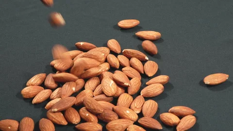 Slow Motion Raw Almonds Falling On Black Background 4K Видео 333674950