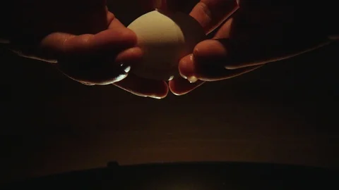 Slow motion raw egg is broken with a knife Stock Footage 120421242