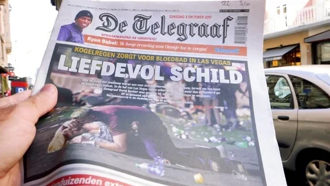 Slow motion reading at Press kiosk about US shootings Stock Footage 80661967