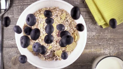 Slow motion ready breakfast with milk, honey and berries top view Video stock 92950842