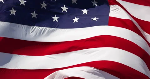 Slow Motion Real American Flag Waving In Wind Against a Deep Blue Sky Stock Footage 156268042