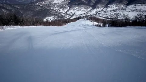 Slow Motion Rear View of Professional Skier Carving Down the Snowy Slope Stock Footage 71891540