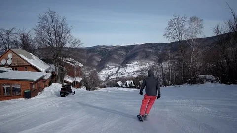Slow Motion Rear View of Professional Skier Carving Down the Snowy Slope 動画素材 71933376