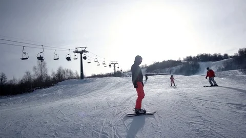 Slow Motion Rear View of Professional Skier Carving Down the Snowy Slope Vídeo Stock 72028300