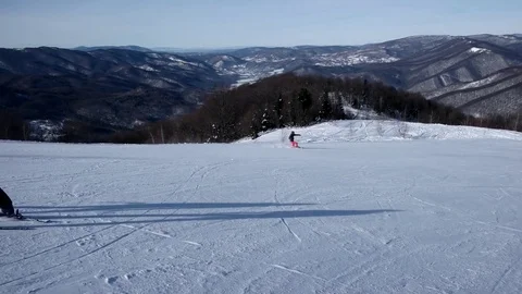 Slow Motion Rear View of Professional Skier Carving Down the Snowy Slope 動画素材 72101876