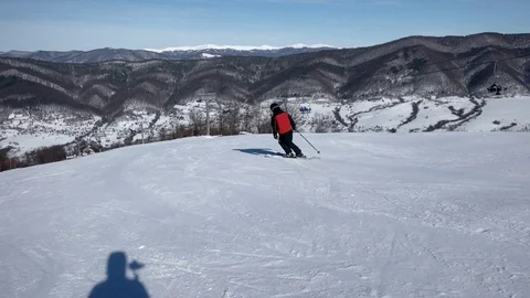 Slow Motion Rear View of Professional Skier Carving Down the Snowy Slope 動画素材 72102967