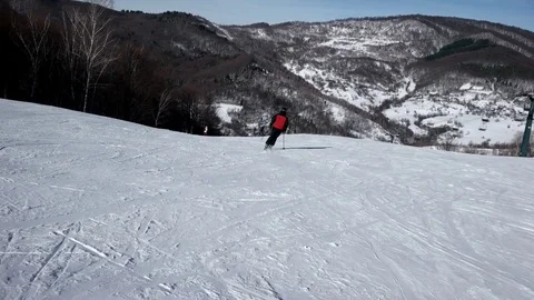 Slow Motion Rear View of Professional Skier Carving Down the Snowy Slope 動画素材 72103648