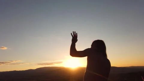 Slow motion rear view of shirtless man silhouette dancing at sunset Stock Footage 346742950