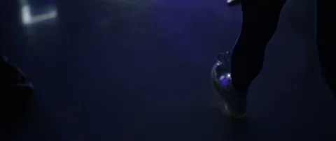 Slow motion rear view of young adult woman walking towards a car in a dark room Stock Footage 126524998