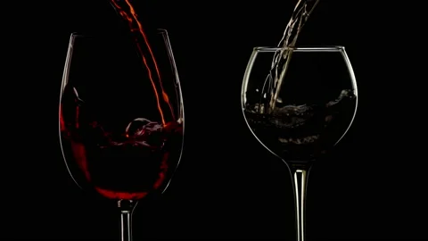 Slow motion red and white wine pour into wine glass. Stock Footage 141449864