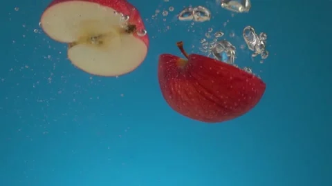 Slow motion red apple halves falls into the water. 스톡 동영상 164477563