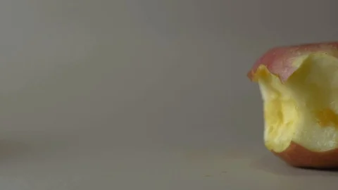 Slow motion red apple with missing a bite isolated on white background 스톡 동영상 107733638