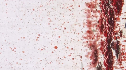 Slow motion red balls of different sizes move horizontally and stop on a vertica Stock Footage 132188636