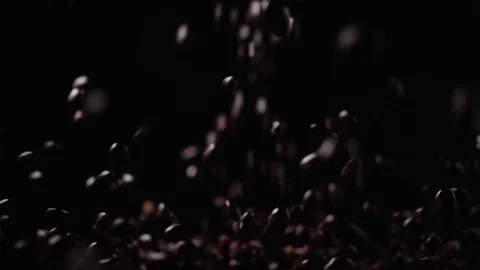 Slow motion red beans fall on a black background Stock Footage 73073561
