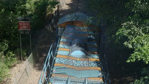 Slow motion, Red Camera: Kuranda rail train leaves a station in Barron Gorge Stock Footage 114420869