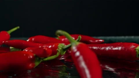 Slow motion of Red chilli pepper flying down Stock Footage 141052364