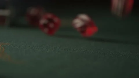 Slow motion of red dice rolling towards camera on green Stock Footage 132730394