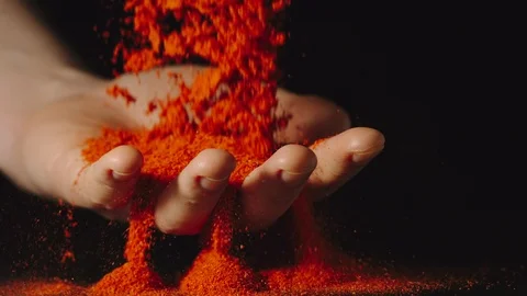 SLOW MOTION: Red pepper falling and passing through man's palm indoors Stock Footage 107501363