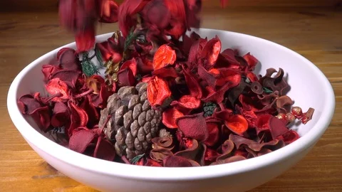 Slow Motion: Red potpourri falling into a plain white bowl. Stock Footage 106067444